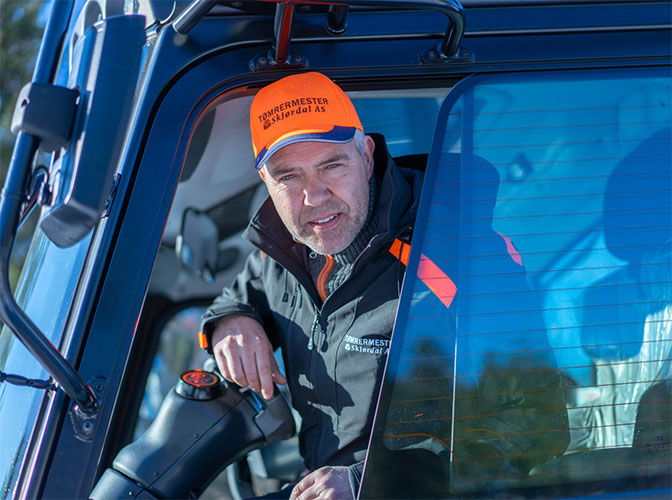 Ole Kristian Skjørdal sitter i førerhuset til løypemaskinen som lager skispor på Vestskauen i Sande i Holmestrand